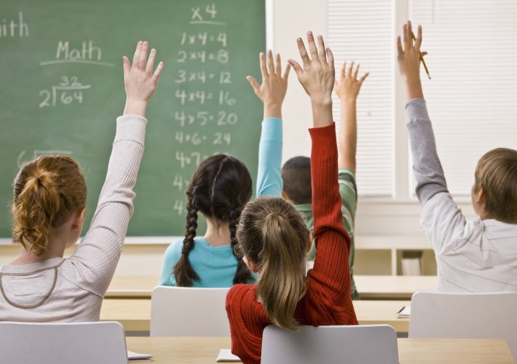 Students Answering Teacher Question; classroom; raising hands; hands raised; (Thinkstock.com) bn