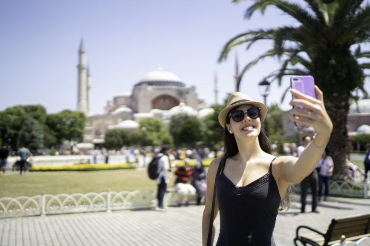 Happy woman taking a selfie in front of Aya Sofya